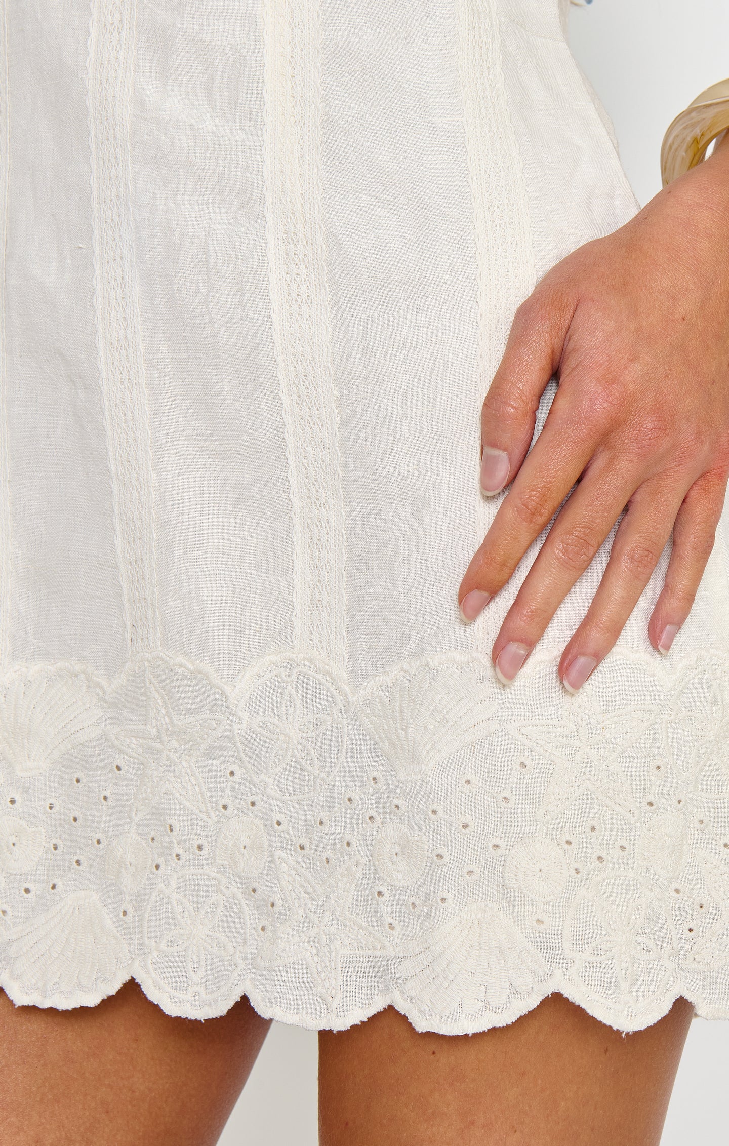 Woman in a white embroidery mini dress