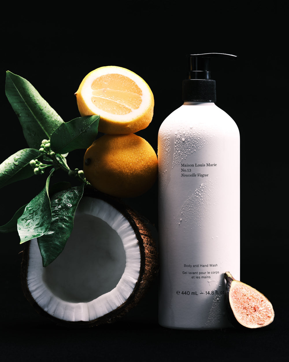 White plastic pump bottle labeled No.13 Nouvelle Vague Body & Hand Wash, for coconut and citrus use, on black background.