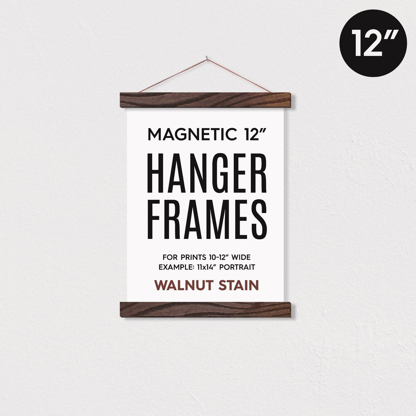 12 magnetic walnut-stained wooden poster hanger frame holding a poster against a white wall.