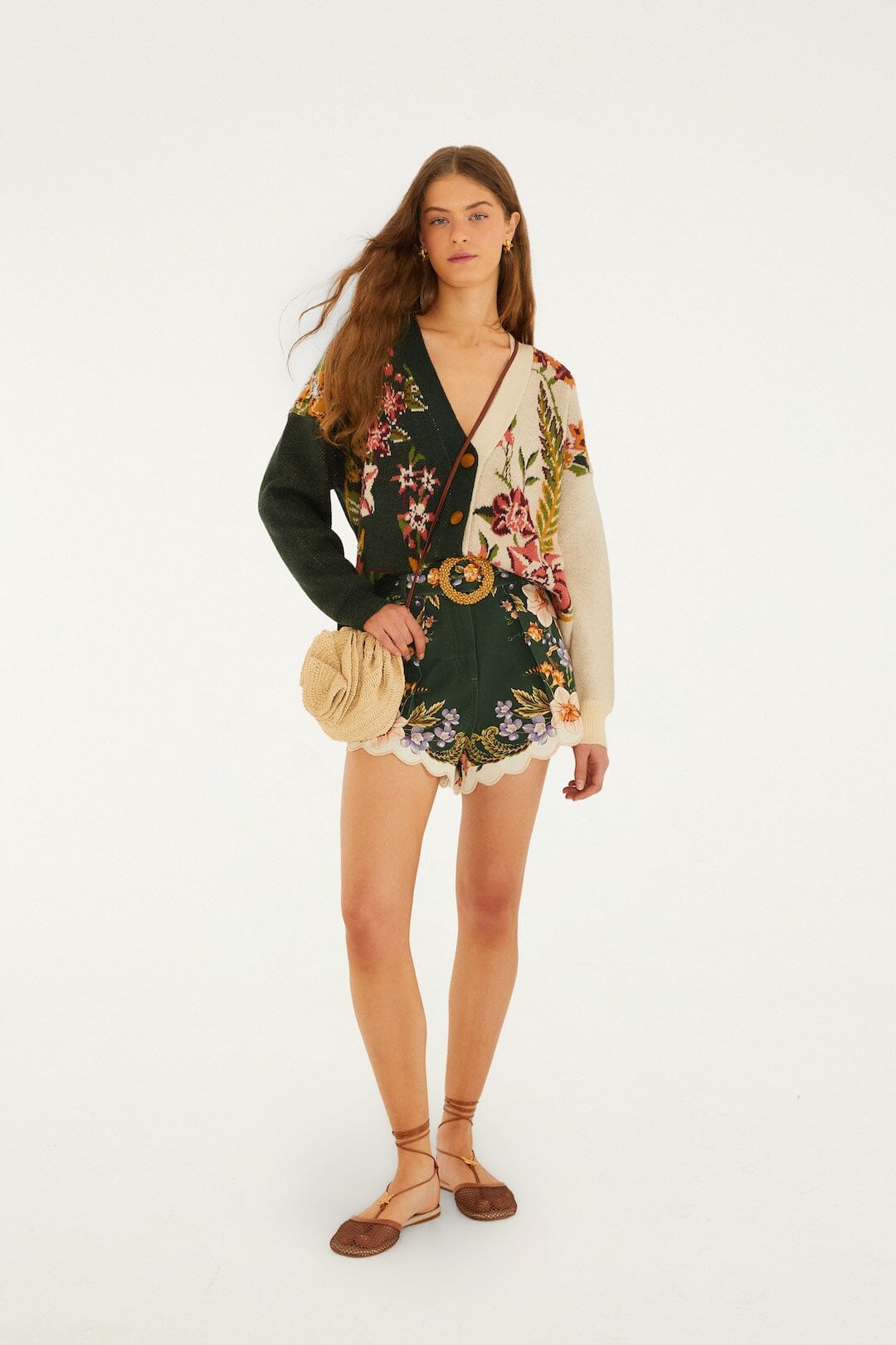 Knit cardigan in nature sand, paired with shorts, sandals, and a round woven bag, set against a white background.