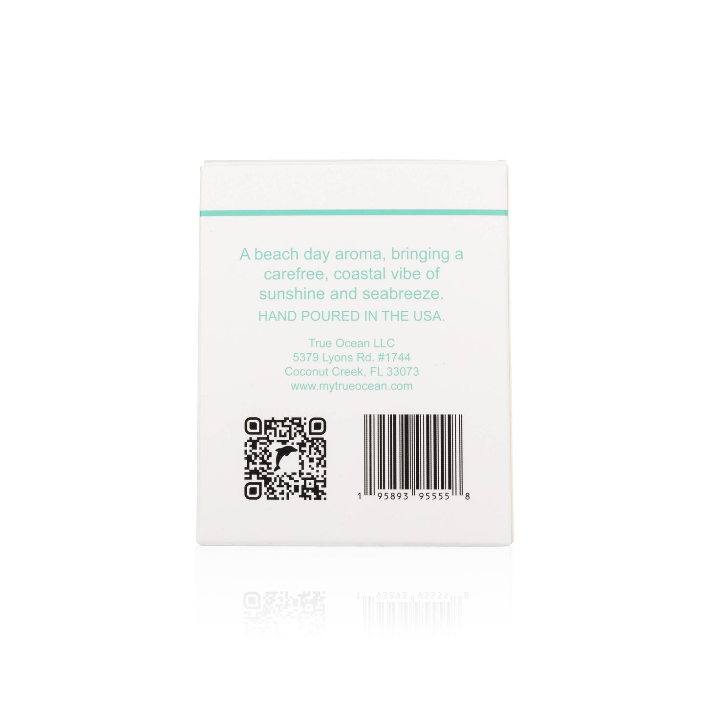White candle box with turquoise text, labeled coastal scent; QR code and barcode visible on the bottom.