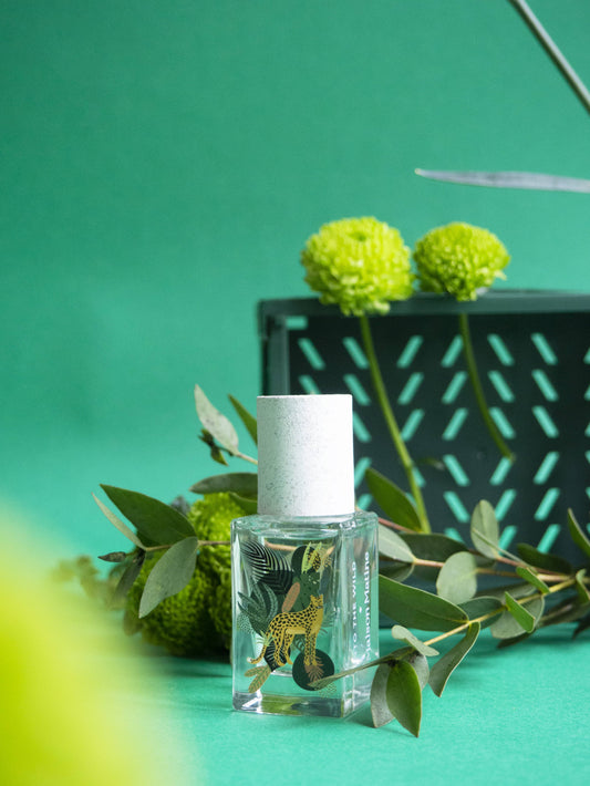 15ml white-capped perfume bottle featuring woody, spicy, and tropical green floral notes. Suitable for personal fragrance use.
