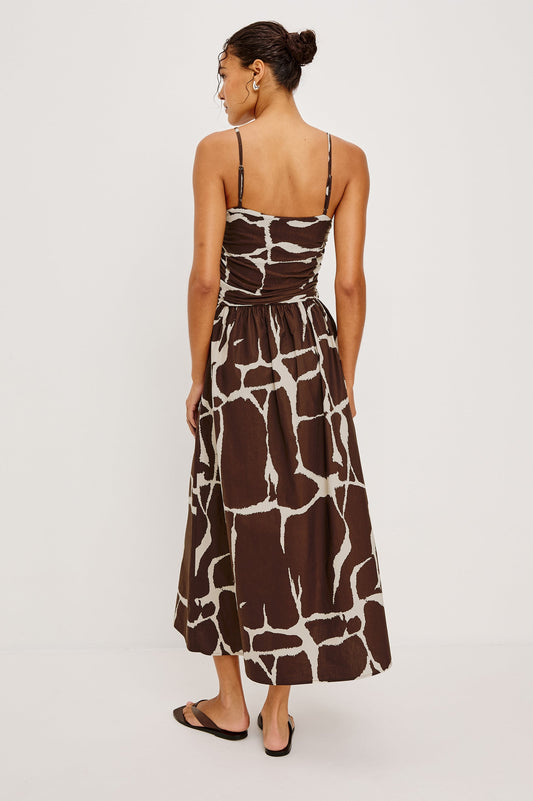 Back view of a terra giraffe-print maxi dress with adjustable straps, suitable for casual or summer wear.