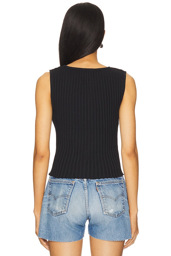Woman in black vest top with buttons