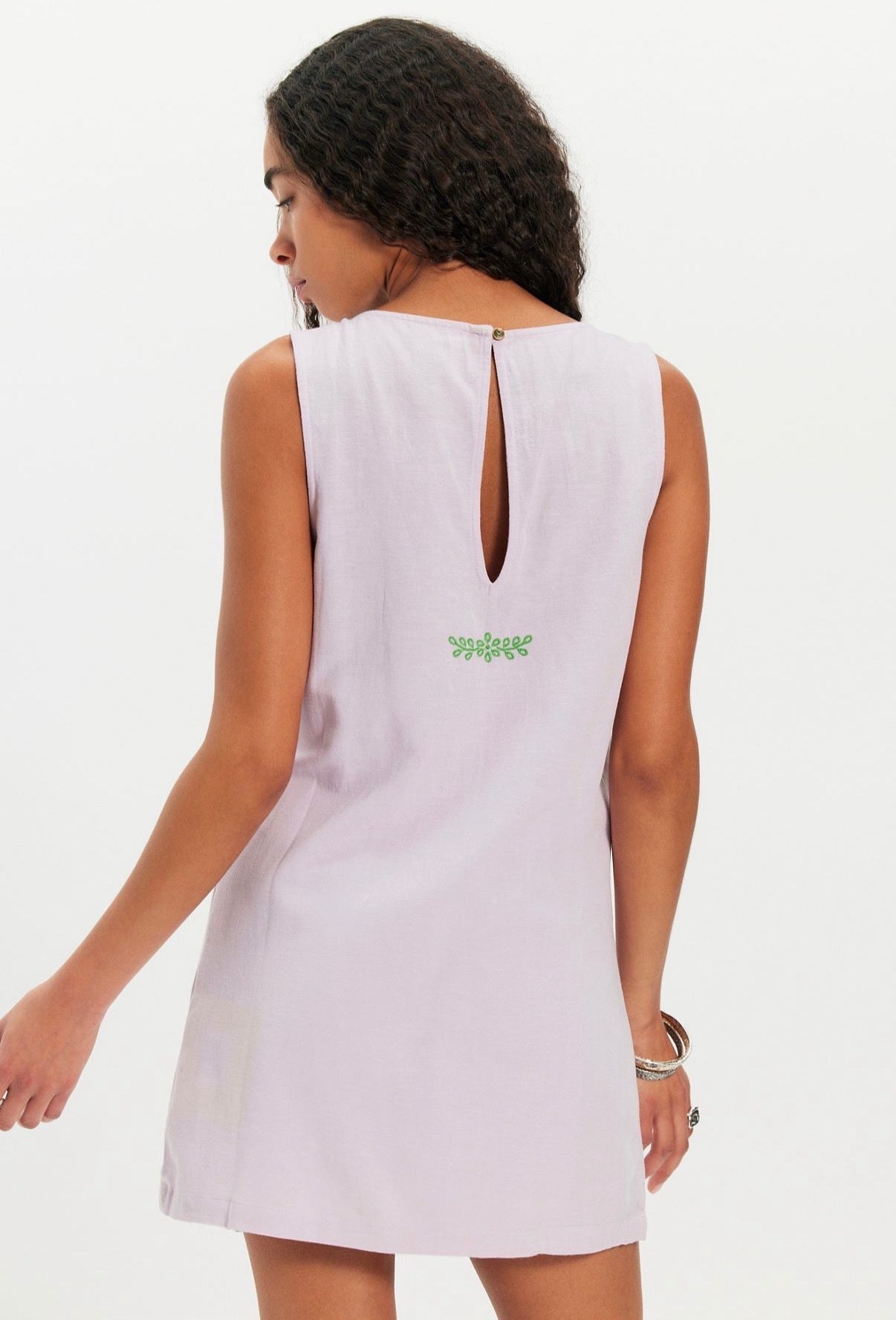 Sleeveless mini dress in pale orchid with embroidered details and a back button keyhole, ideal for casual wear.