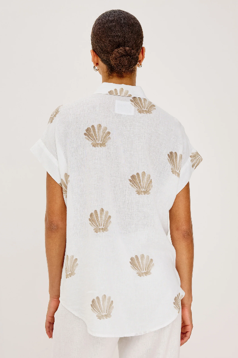Back view of person in a light taupe, printed button-up shirt made from lightweight fabric, suitable for casual wear.
