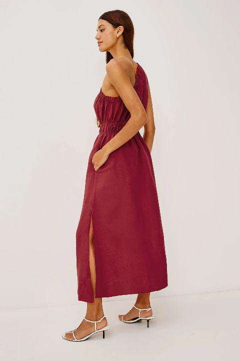 Selani spice-colored dress with side slit, styled with white heeled sandals. Suitable for casual or semi-formal wear.