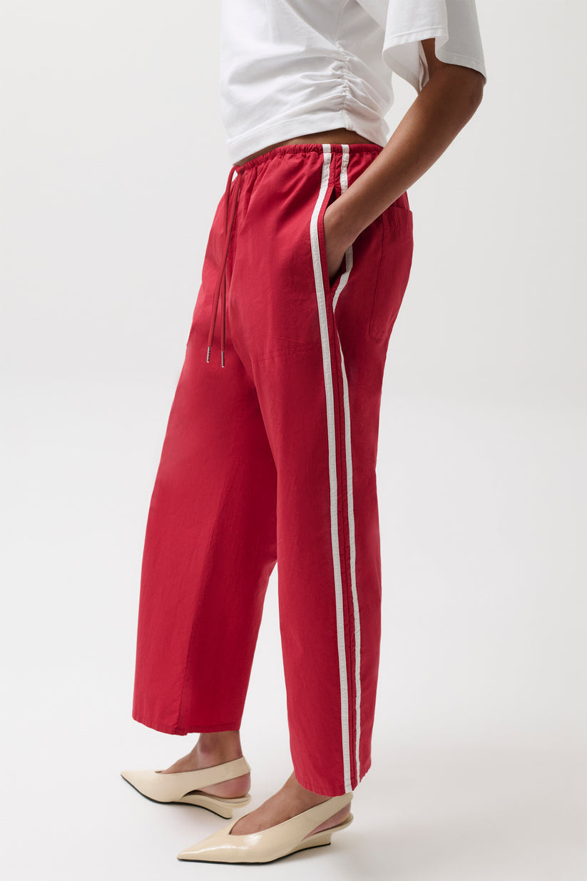 Woman wearing red pants with white stripes