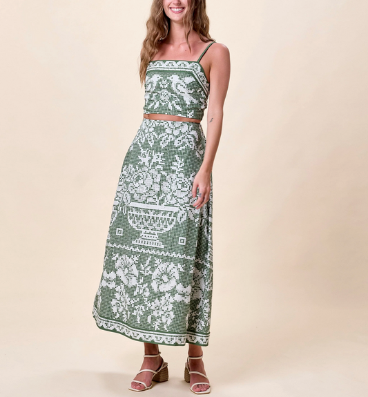 Woman in a green floral organic cotton ankle skirt, smiling. Skirt is lightweight, handmade, and casual.