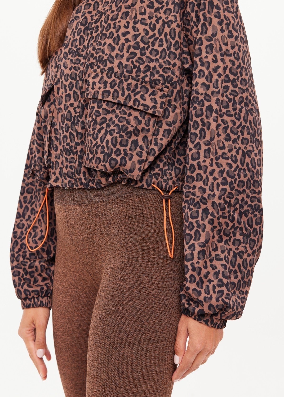 Woman wearing a leopard jacket with orange drawstrings
