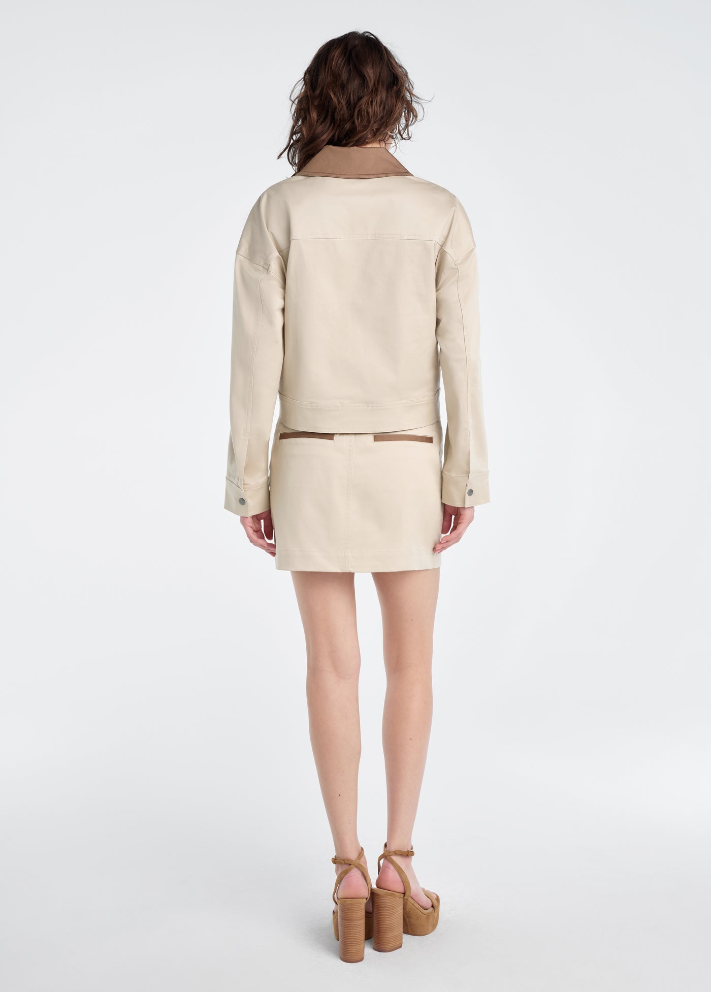 Woman wearing a beige jacket with khaki accents