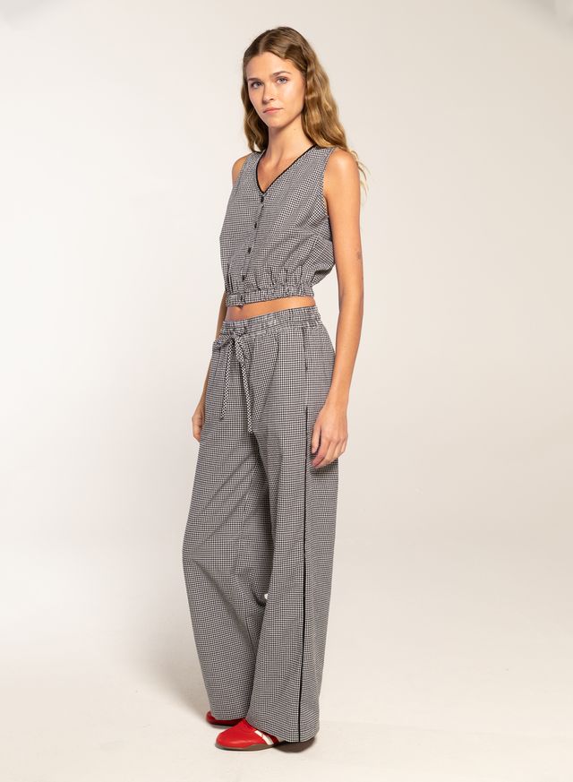 Woman in black gingham button top and pants