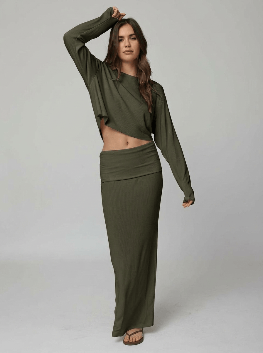 Woman wearing an olive top and skirt