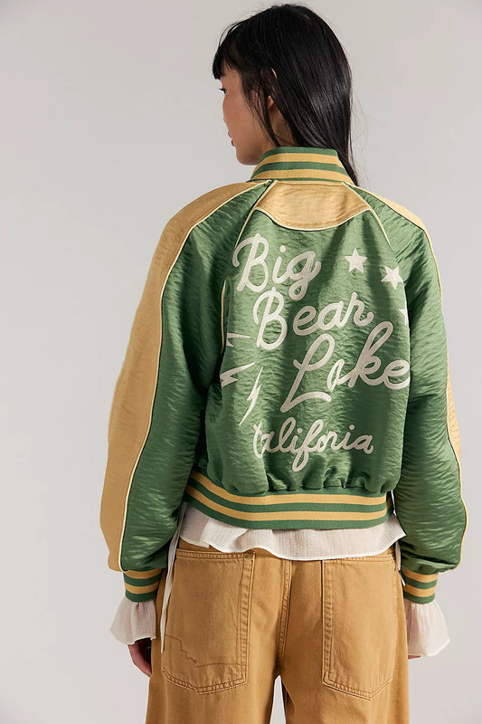 Vintage green souvenir jacket with Big Bear Lake California on the back, worn by a woman.