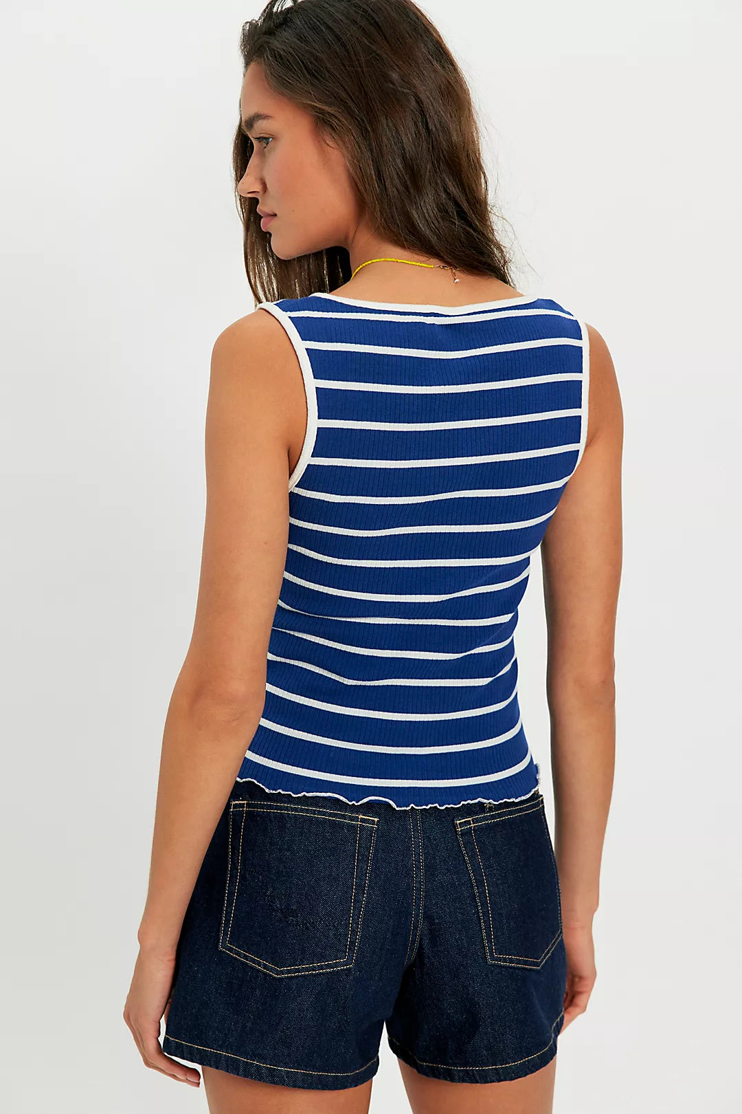 Woman wearing a blue and white striped sleeveless top