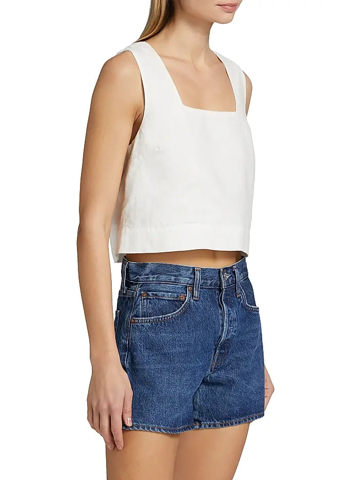 Woman wearing a white sleeveless top 