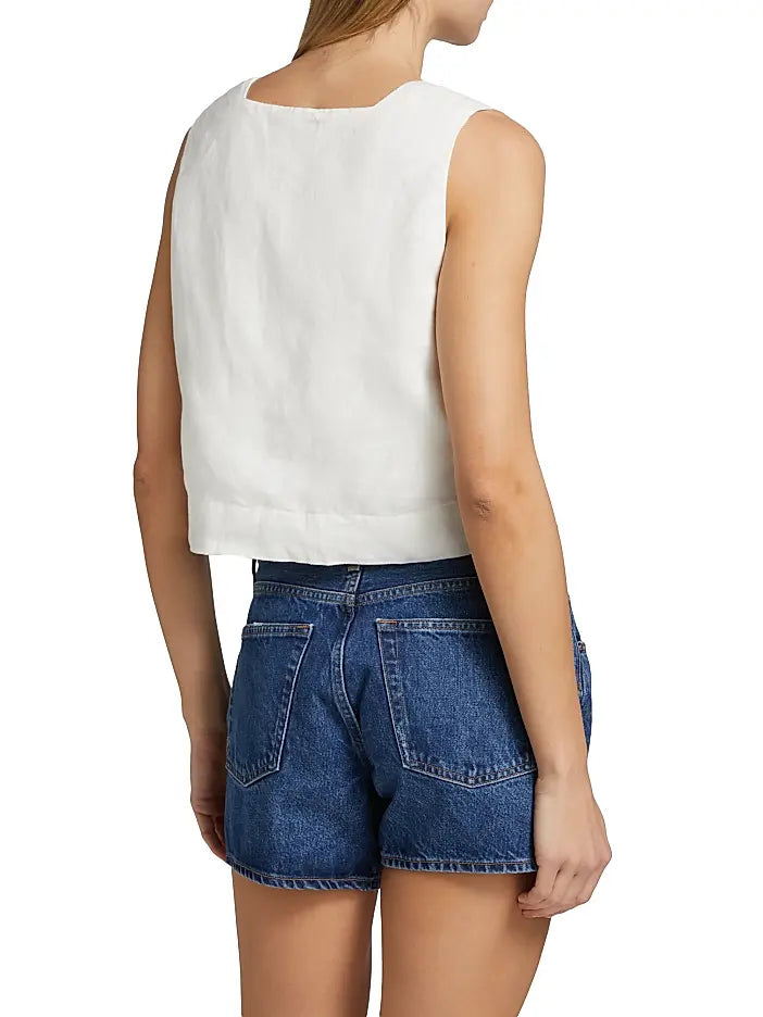 Woman wearing a white sleeveless top 