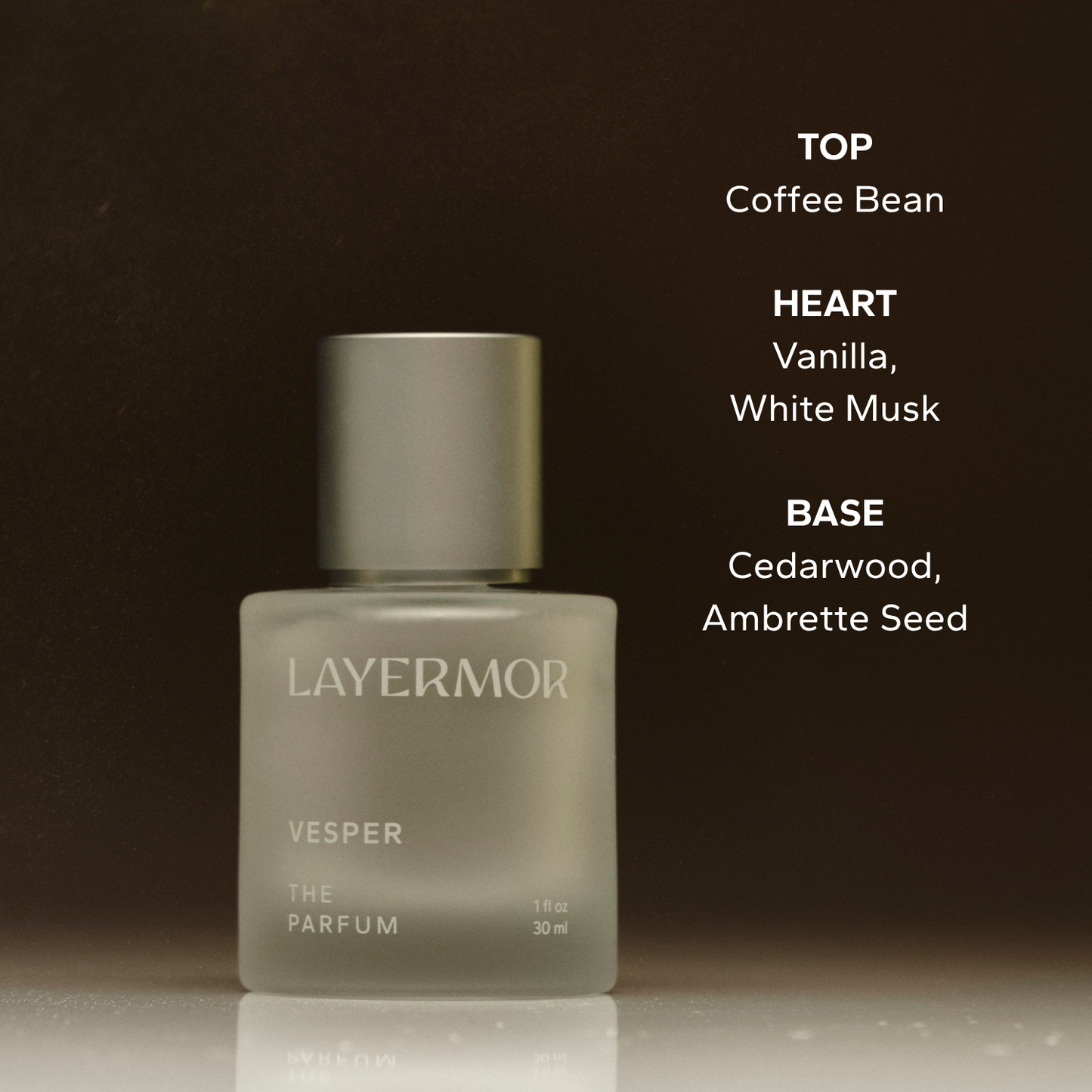 Clear glass bottle containing Vesper perfume, featuring notes of coffee, vanilla, musk, cedarwood, and ambrette seed.