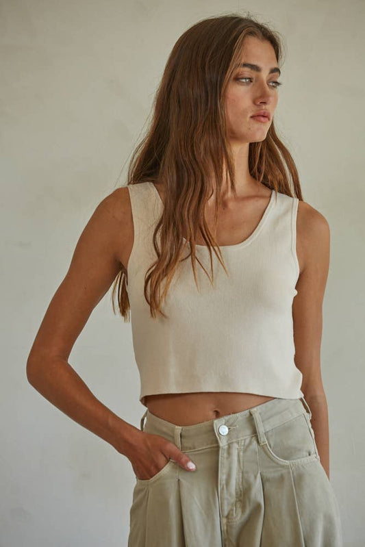 Woman in cream tank top with long brown hair, modeled from the side. Boho-inspired, casual wear.