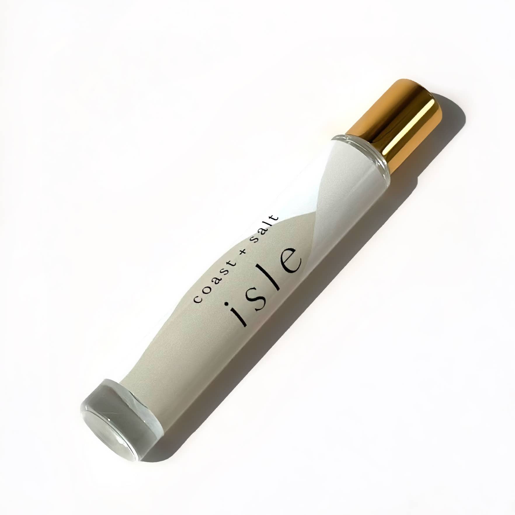 Gold-capped Isle perfume roller by Coast+Salt, clear glass, on a white surface; designed for easy fragrance application.