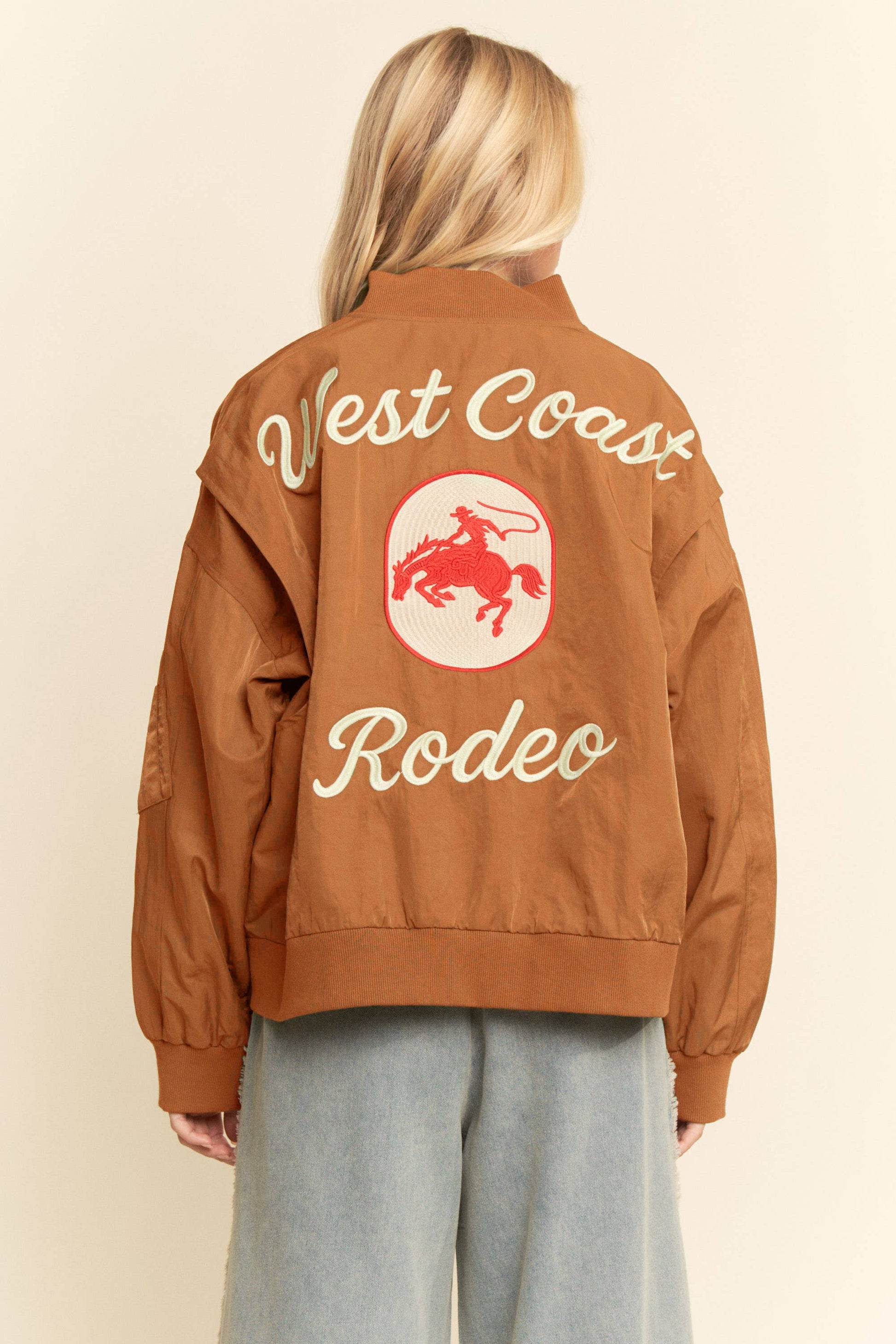 Embroidered bomber jacket with red rodeo graphic on the back; ideal for casual or outdoor wear.