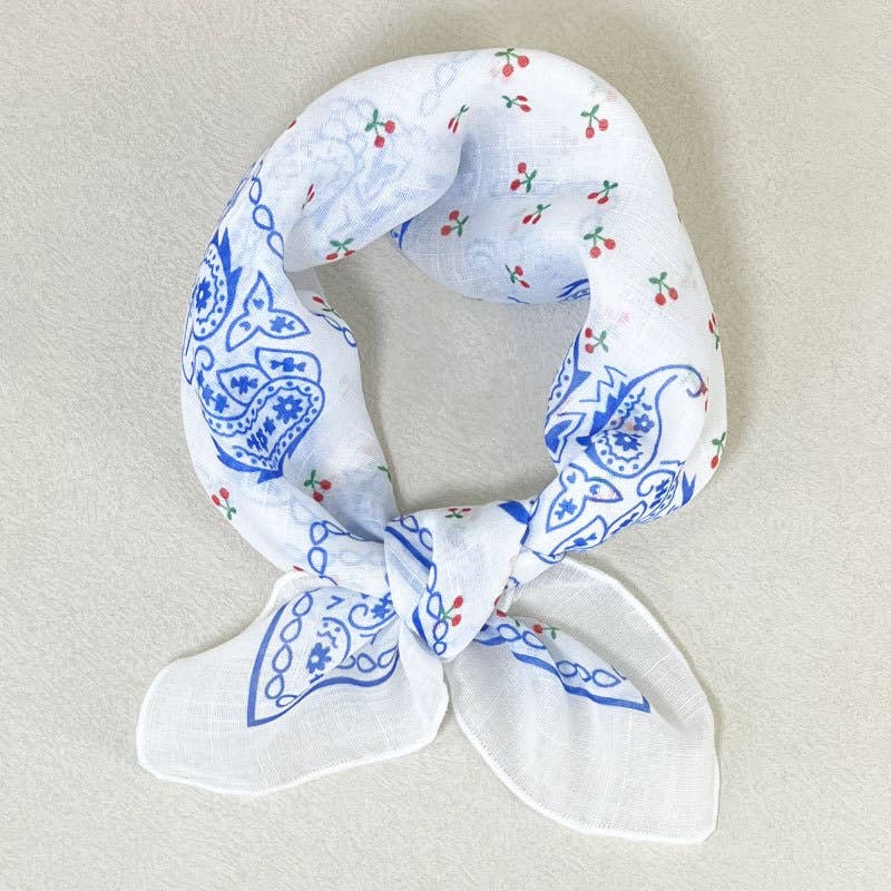 White cotton bandana scarf with blue paisley and red-green floral prints, suitable for casual or accessory wear.