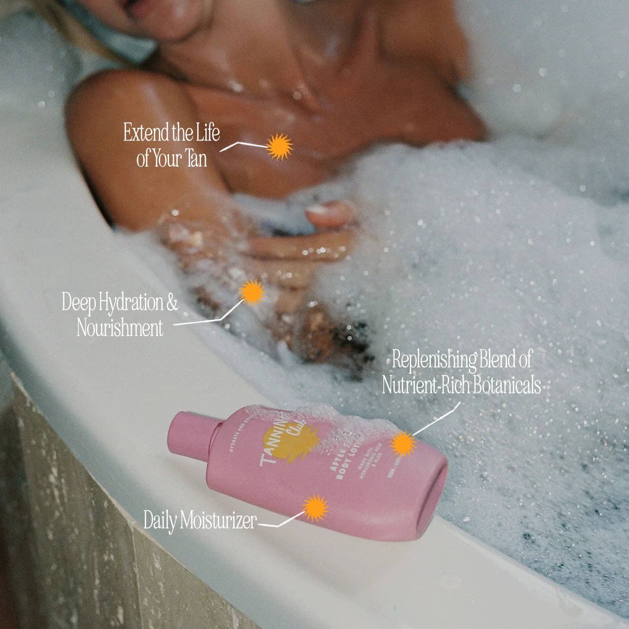 Person in a bath using white lotion bottle for tan extension and skin care.