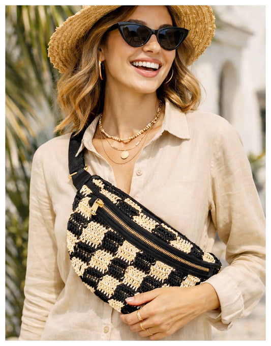 Woman in sunglasses and straw hat wears a beige shirt with a checkered fabric sling bag, suitable for everyday use.