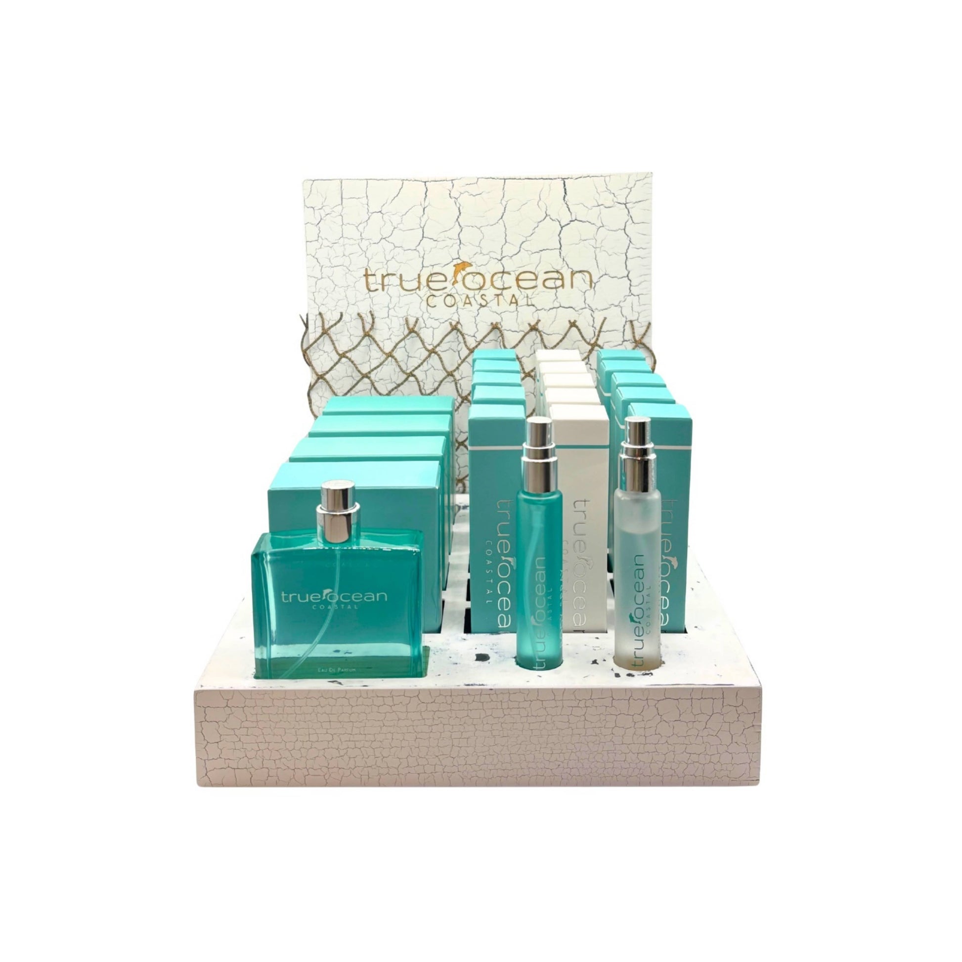 Travel-size blue body spray bottles and matching boxes arranged on a textured white display stand.