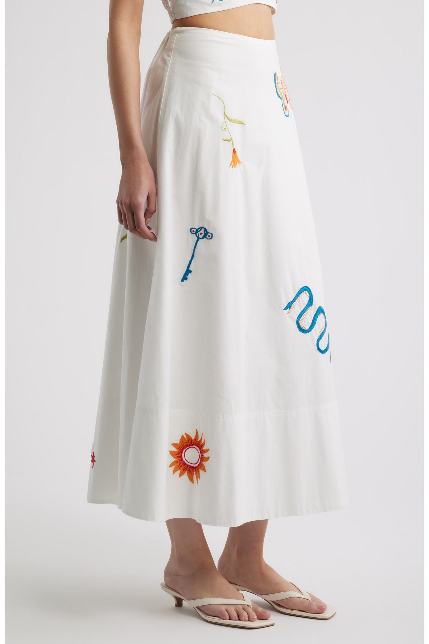 Woman in a white skirt with colorful embroidery