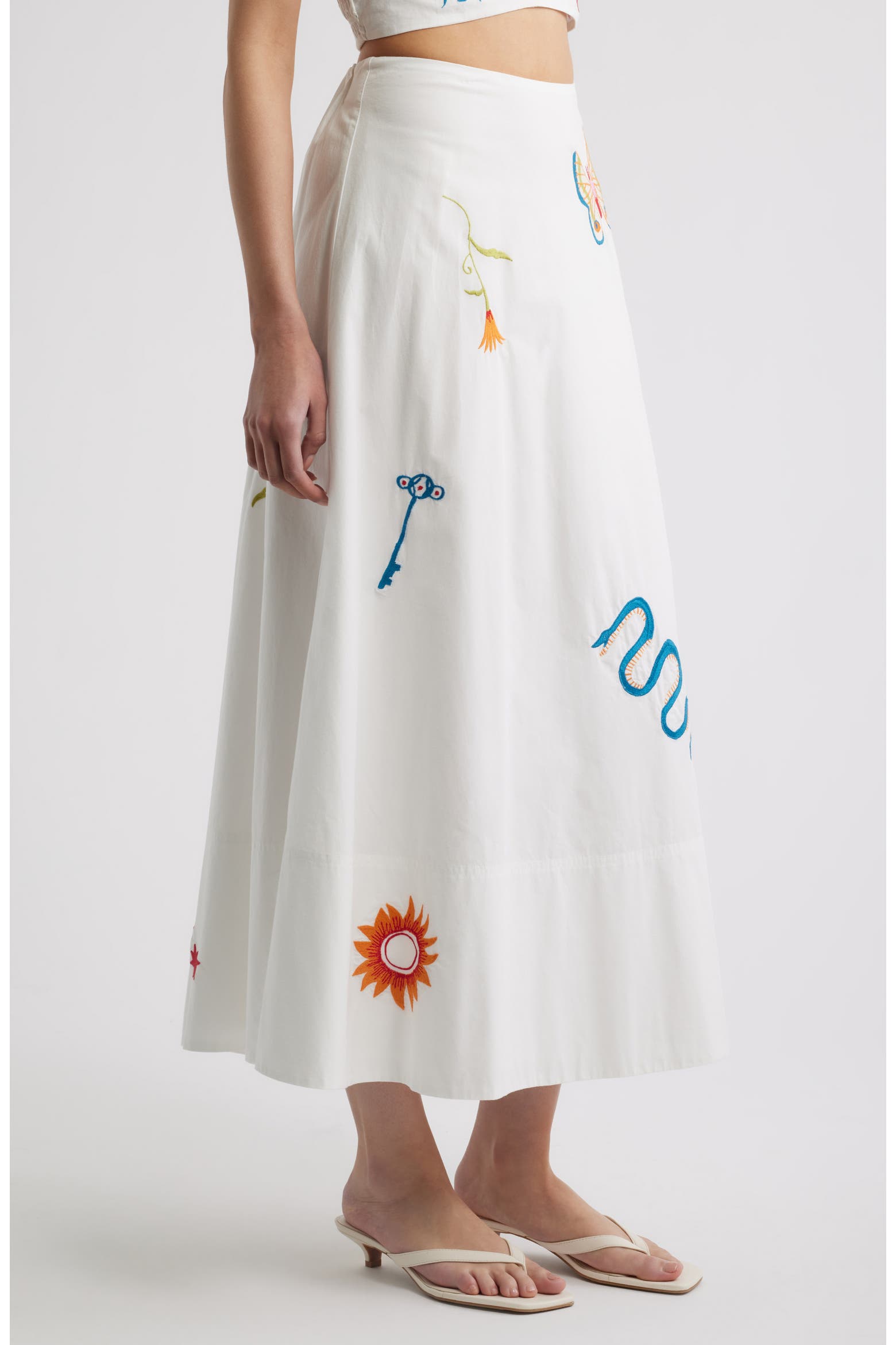 Woman in a white skirt with colorful embroidery