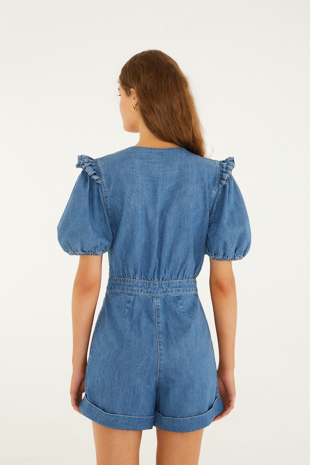 Back view of denim short-sleeve romper with ruffled shoulders, suitable for casual wear.