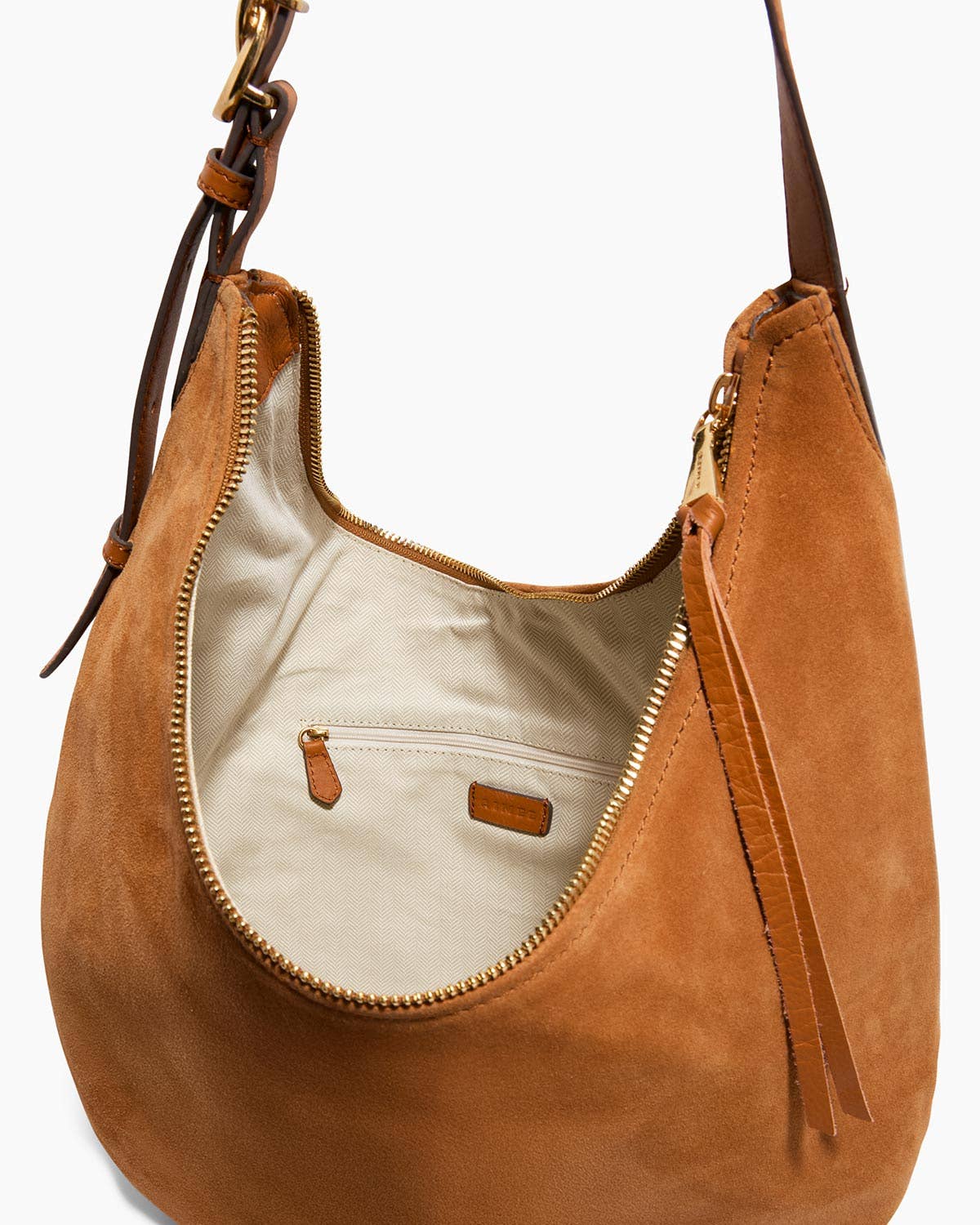 Tan suede large hobo bag with gold zipper, brown strap, and beige fabric interior pocket. Ideal for everyday use.