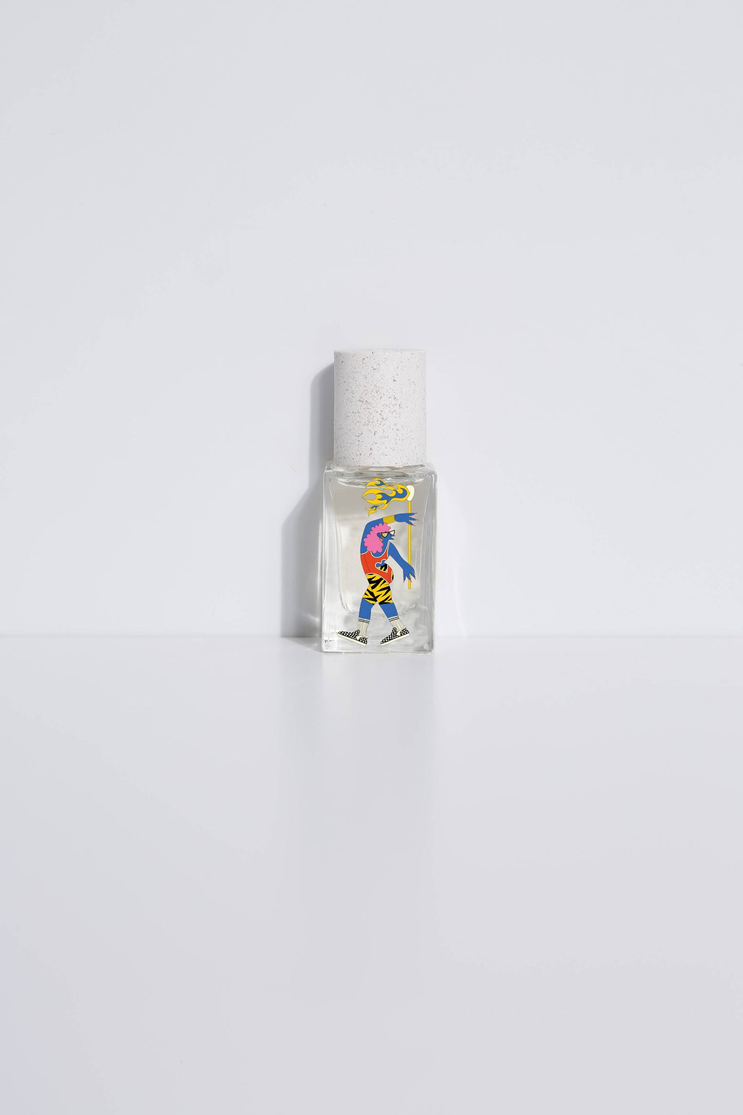 Clear glass 15ml perfume bottle with abstract art label, designed for personal fragrance, shown on a white surface.
