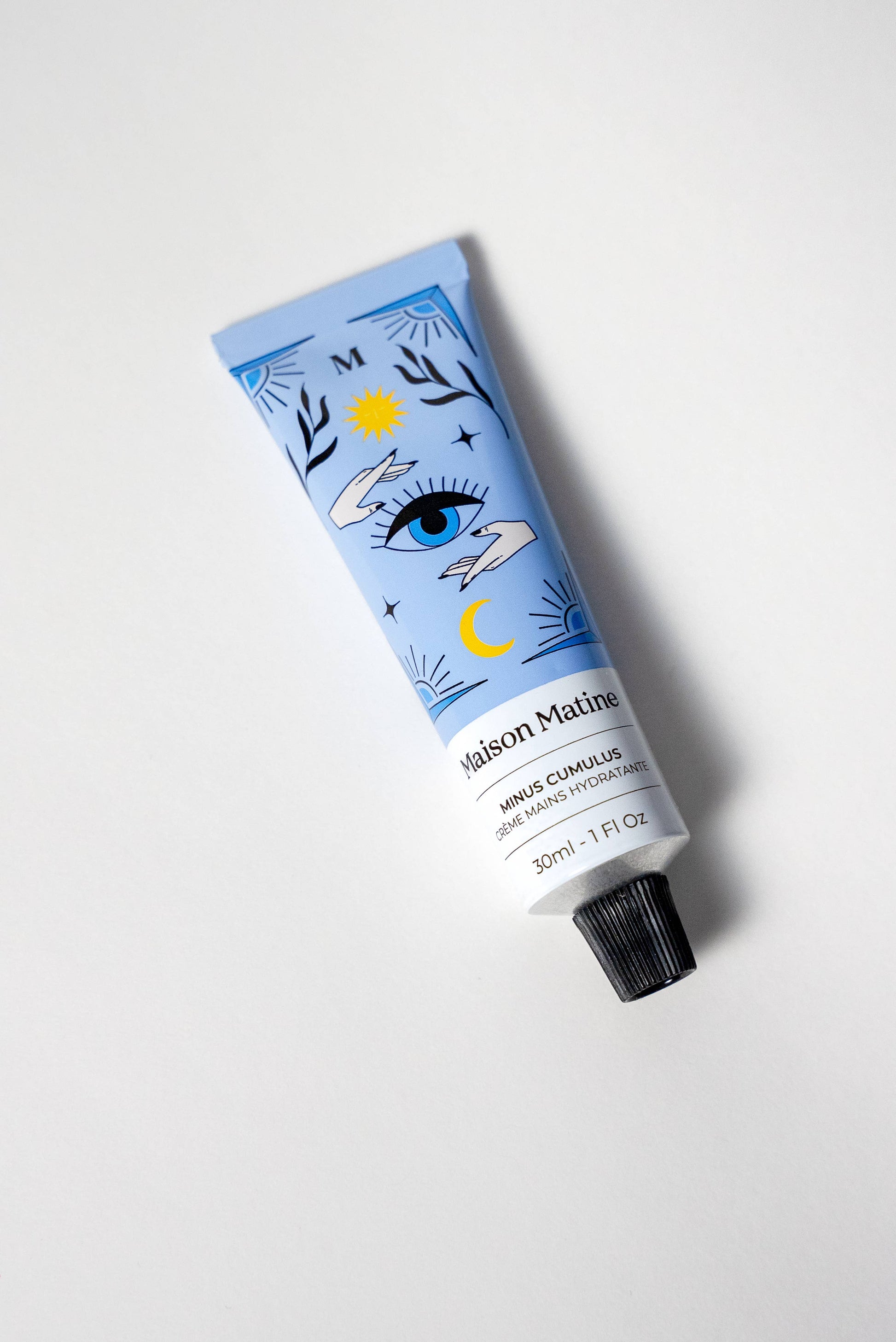 Blue Maison Matine Minus Cumulus hand cream tube, 30ml, featuring eye, sun, and moon designs on white background.
