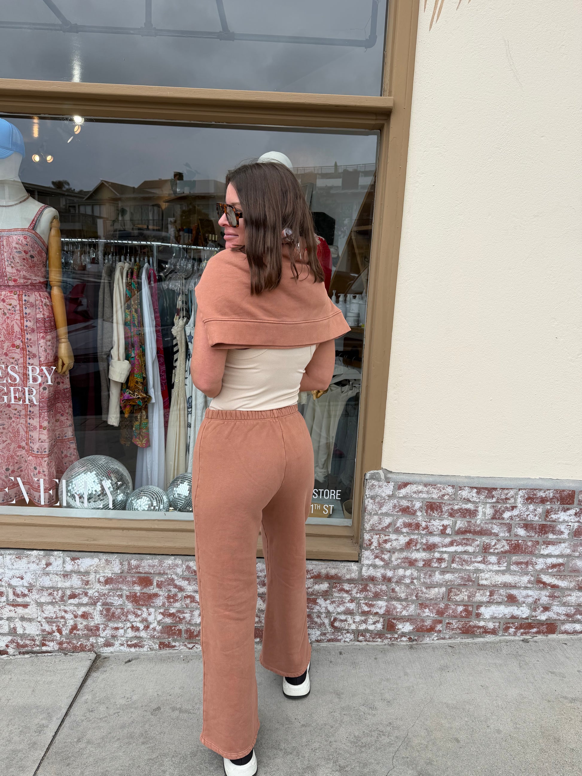 Back view of woman outdoors wearing wide leg birch-colored pants, relaxed fit, lightweight fabric, ideal for casual wear.