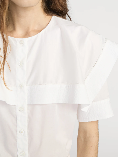 Woman in white cotton cape shirt with wide layered collar and button-down front, suitable for casual or office wear.