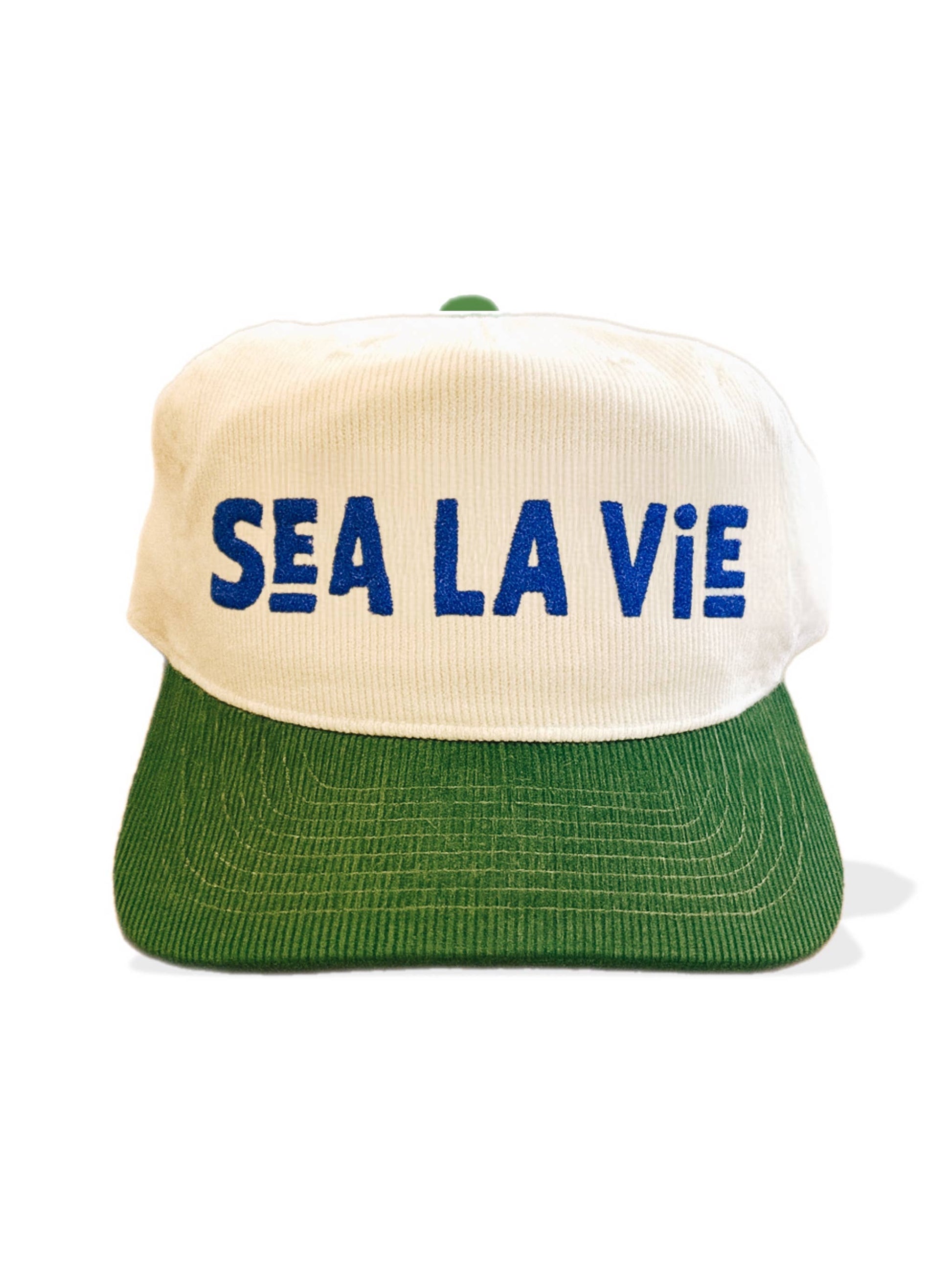 White and green corduroy hat with blue embroidered front lettering; casual headwear suitable for everyday use.