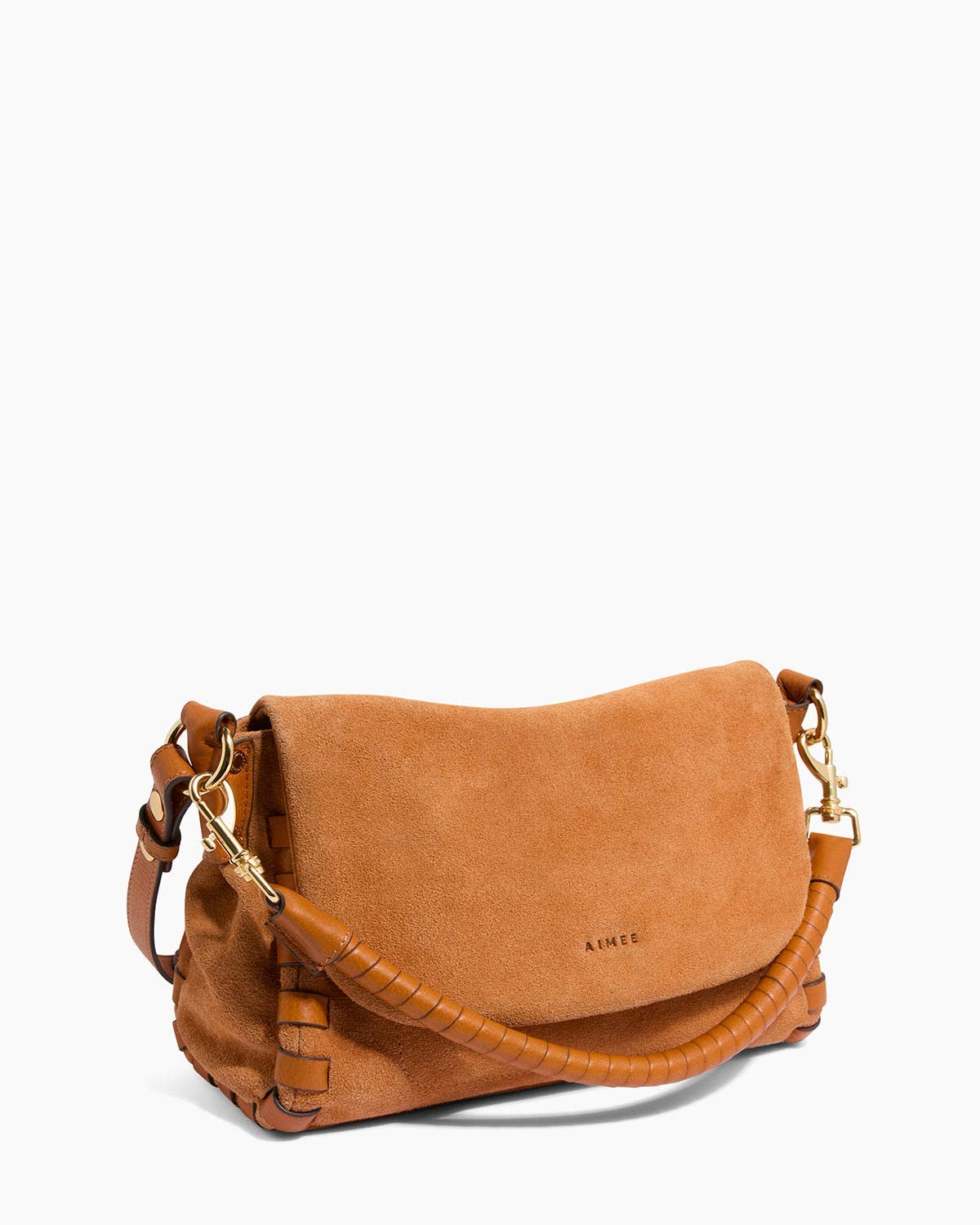 Tan suede crossbody bag with hand-woven handle, flap closure, and strap displayed on a white background.
