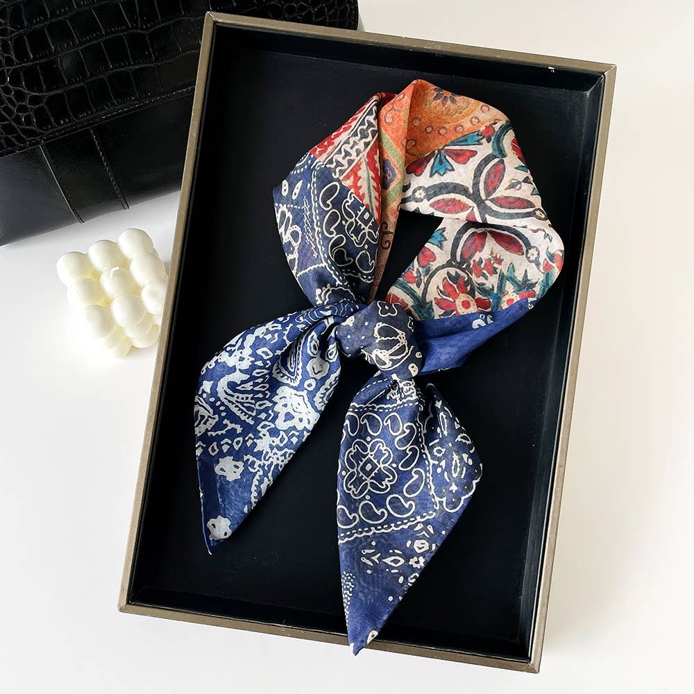 Paisley patchwork bandana in bow shape, cotton material, black pattern, displayed in box with purse and beaded bracelet.