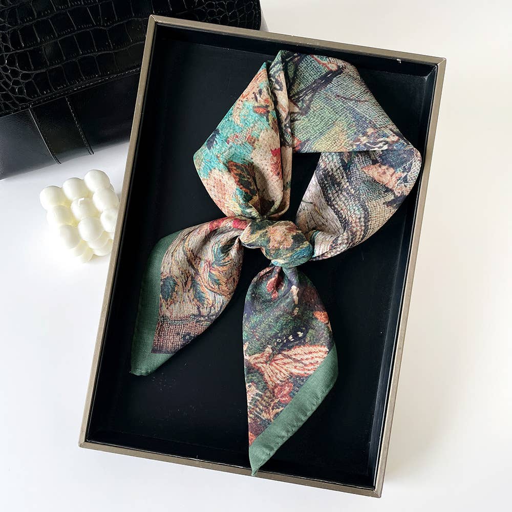 Green-edged paisley patchwork bandana, cotton, presented tied in a bow inside a black box.