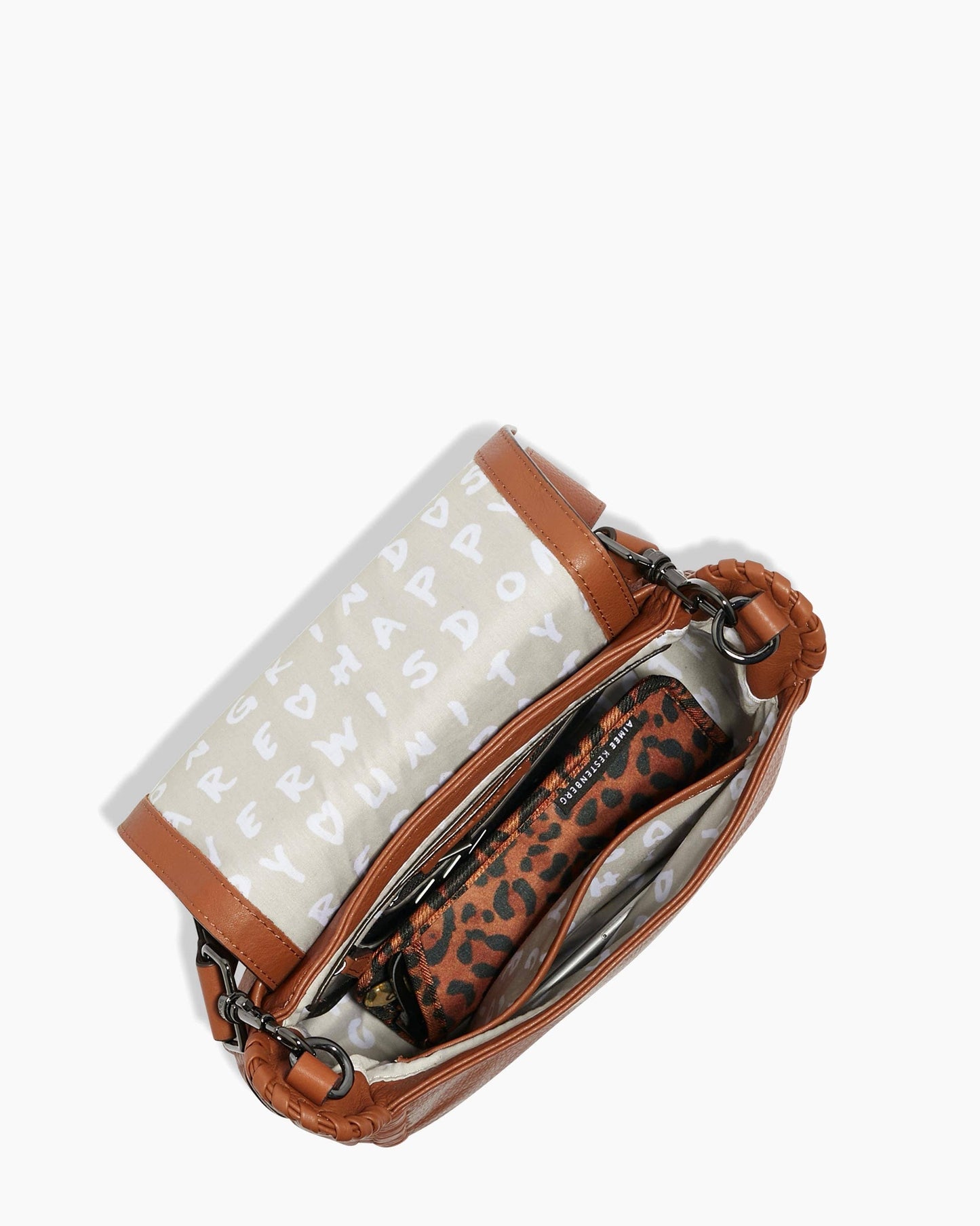 Brown crossbody bag with patterned lining, animal print pouch, multiple compartments, and adjustable strap.