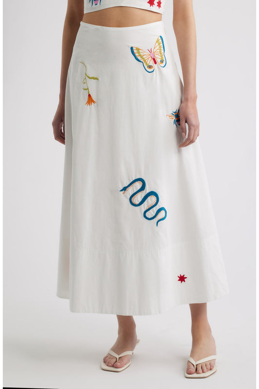 Woman in a white skirt with colorful embroidery