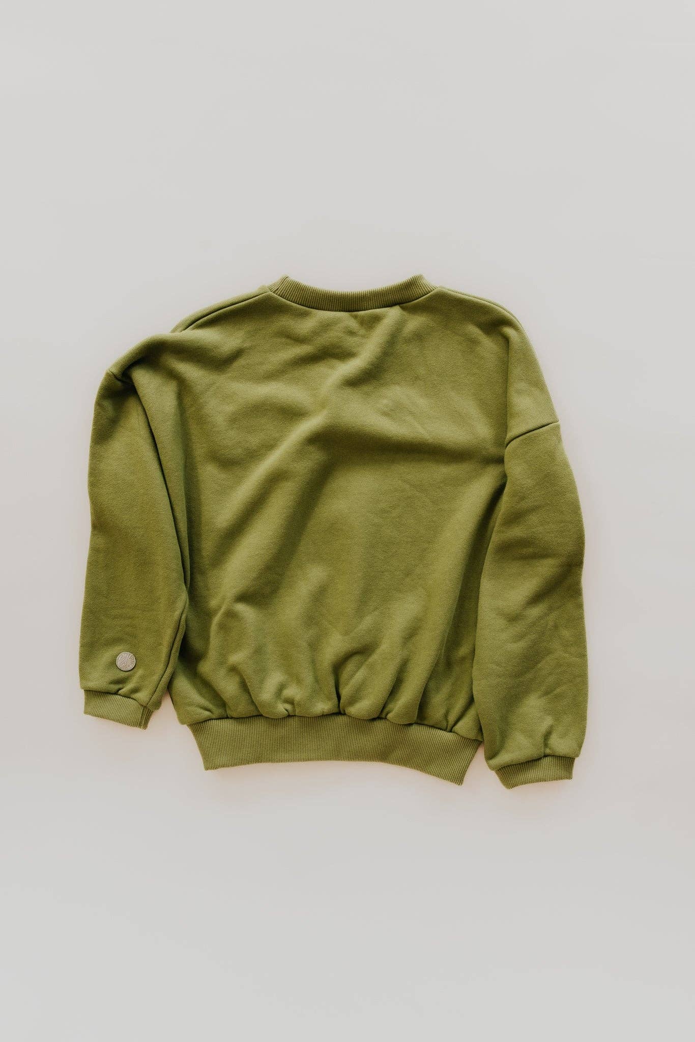 Green cotton sweatshirt with tiger patch, shown from the back, laid flat on a white surface.