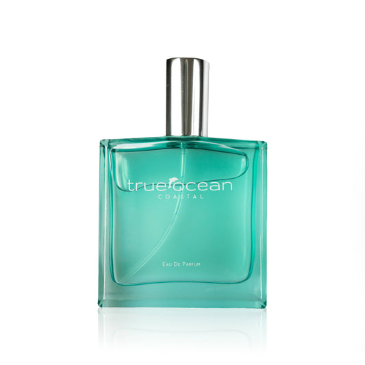 Teal glass perfume bottle with a silver cap and True Ocean label on a plain white background.