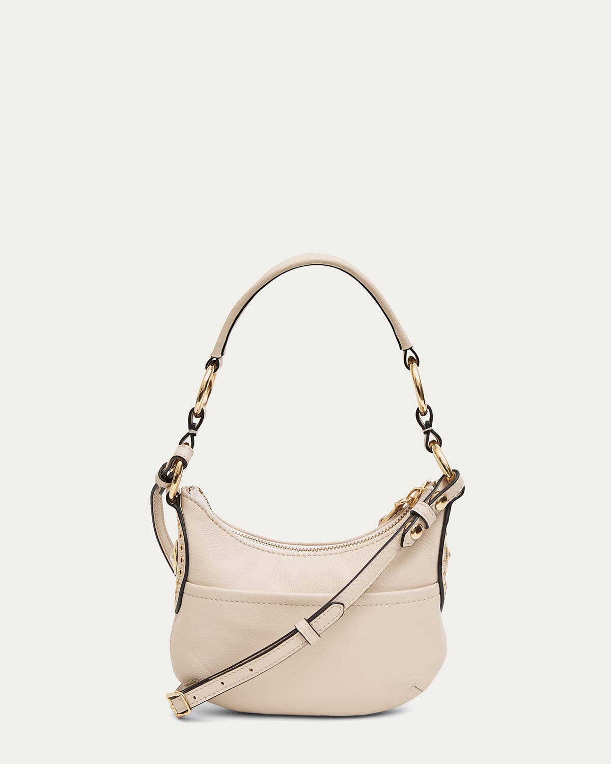 Cream leather crossbody bag with gold hardware, wide strap, and a curved top handle for versatile use.