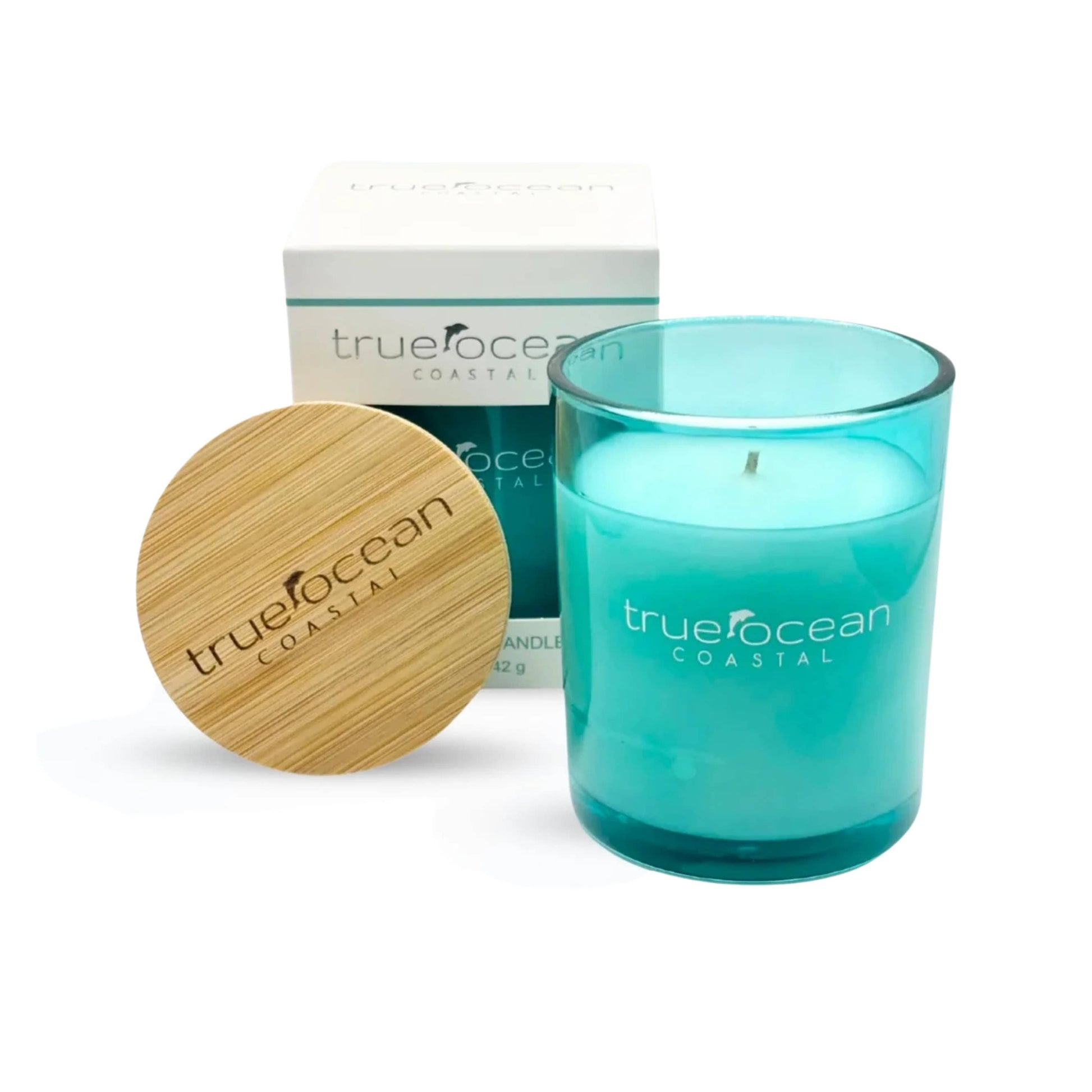 Blue glass soy wax candle with wooden lid and box, featuring True Ocean branding.