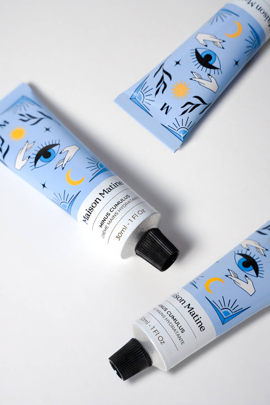 Three blue Maison Matine Minus Cumulus Hand Cream tubes, 30ml each, feature eye, star, and moon graphics on the packaging.