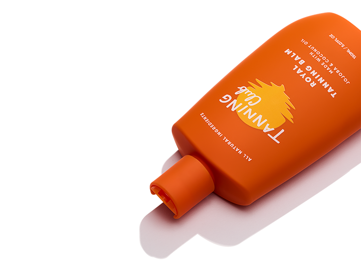 Orange plastic tanning balm bottle with flip-top cap, positioned diagonally on a white background.
