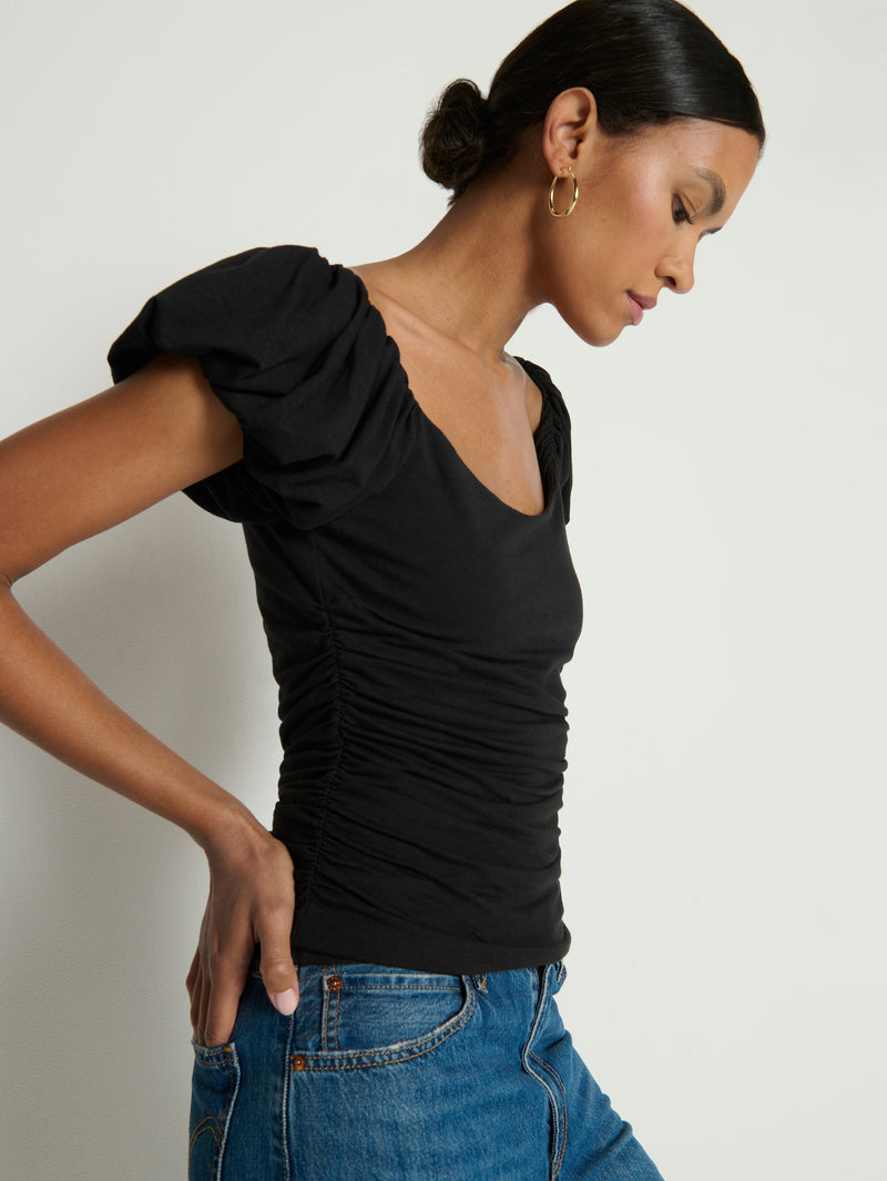 Woman wearing a black top with ruffled sleeves 